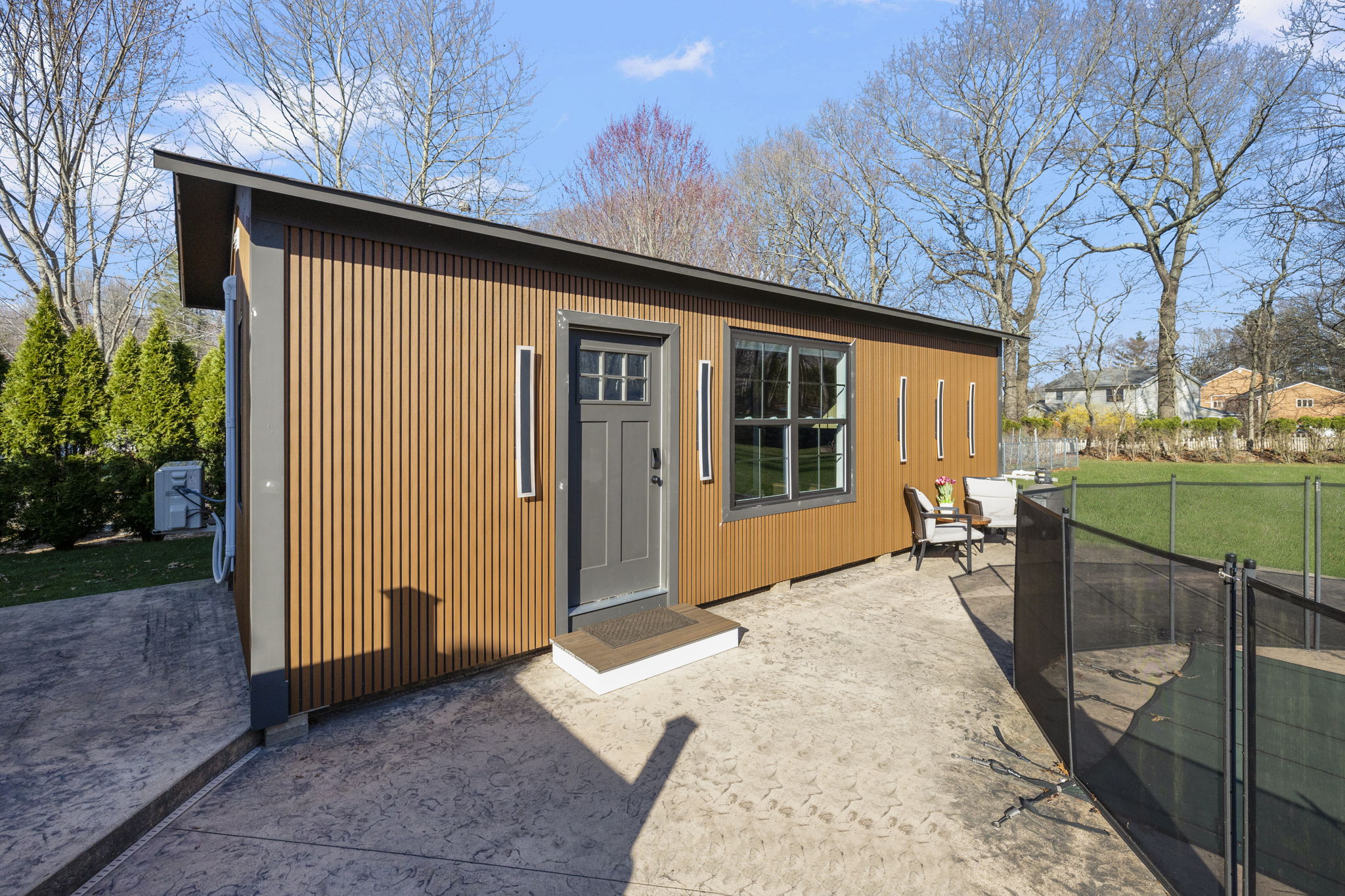 ADU exterior — cedar siding, craftsman door