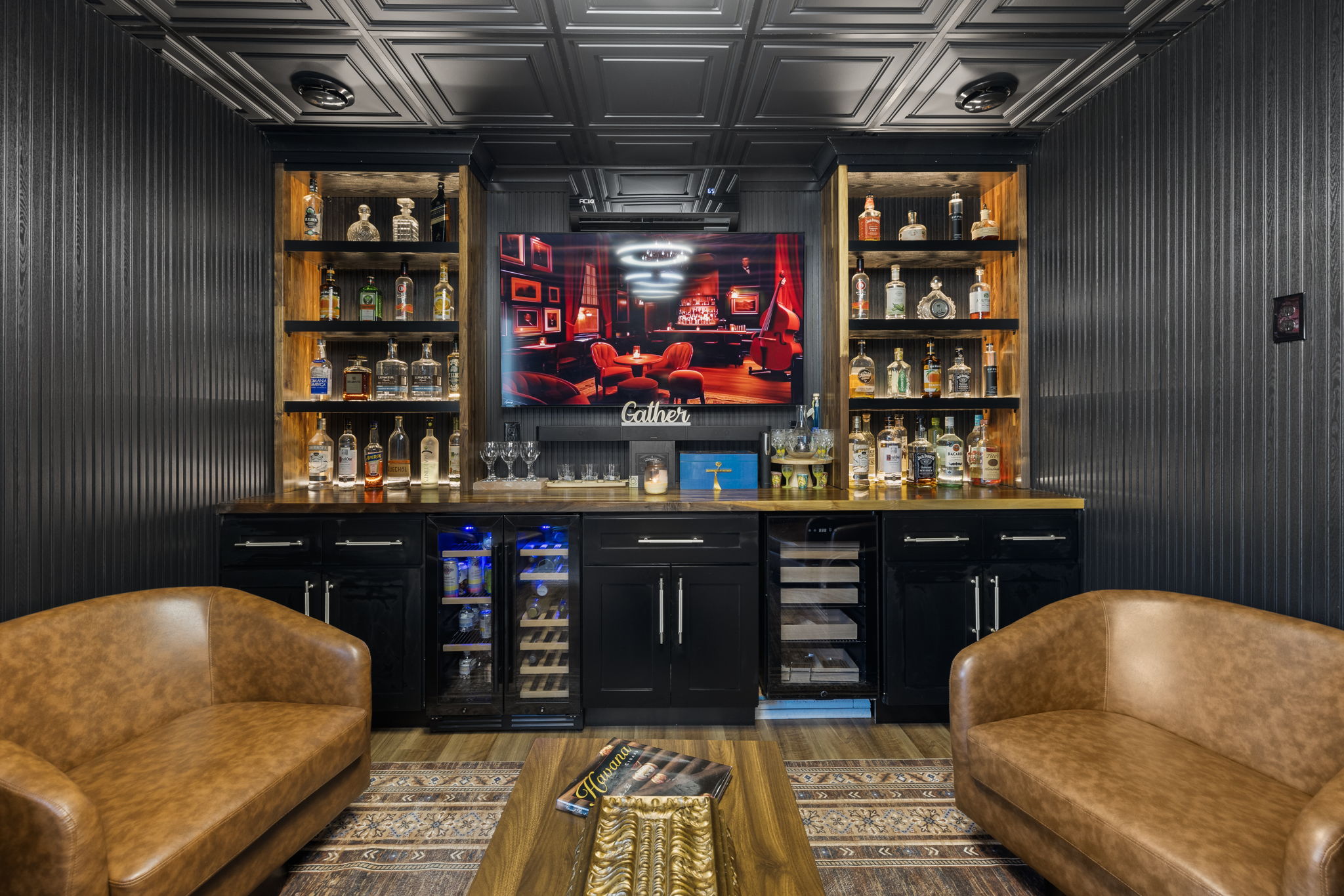 Full bar wall — bottle shelving, wine fridge, built-in humidor, TV